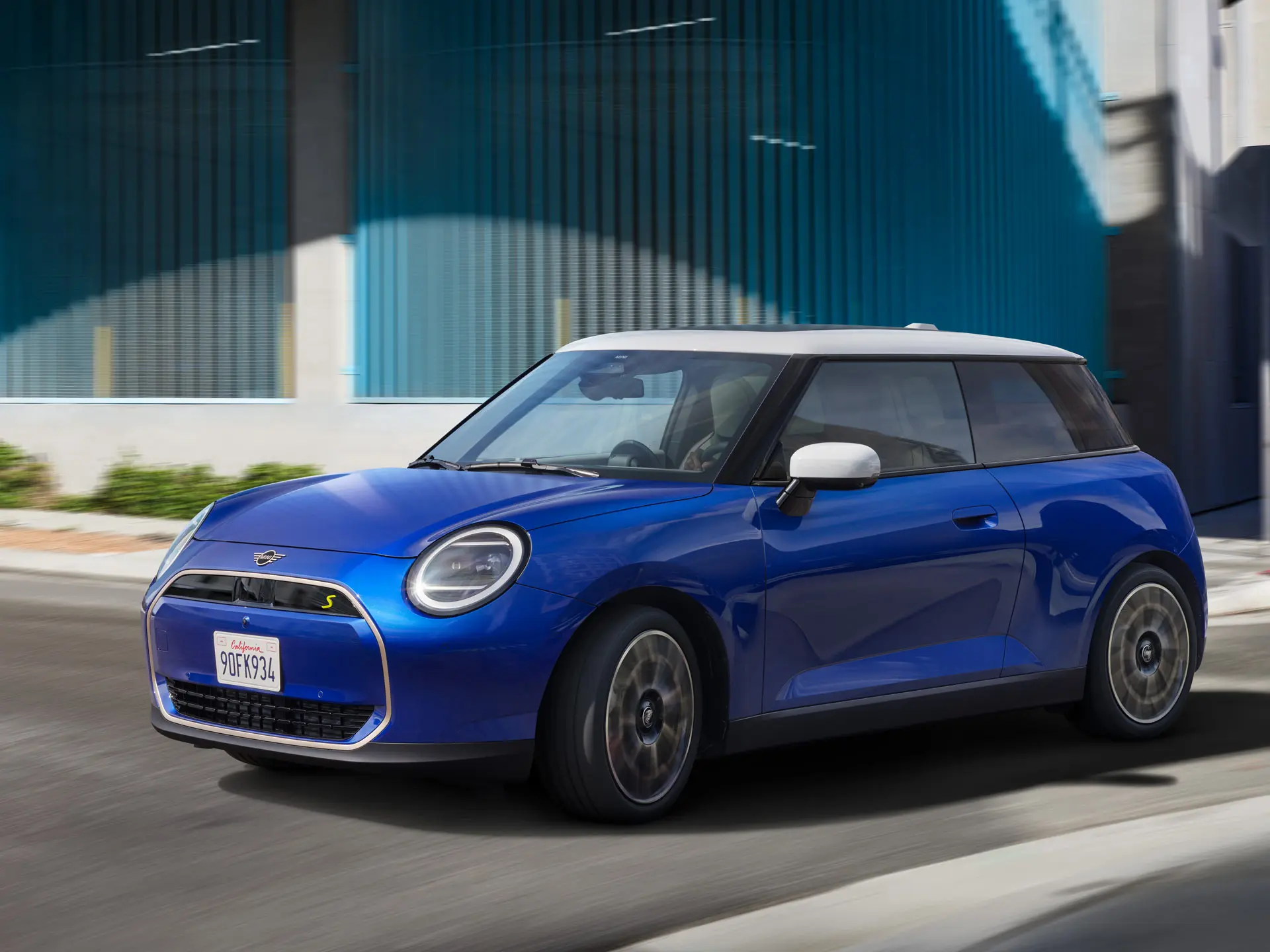 A MINI Cooper drives dynamically